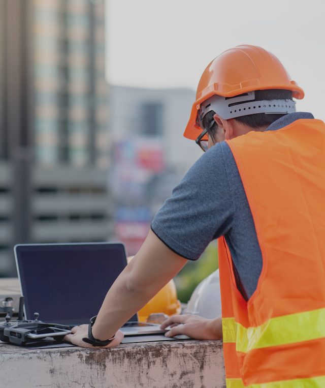 construction worker on laptop